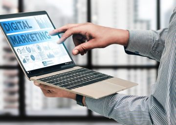 Accountant using digital marketing tools on a laptop.