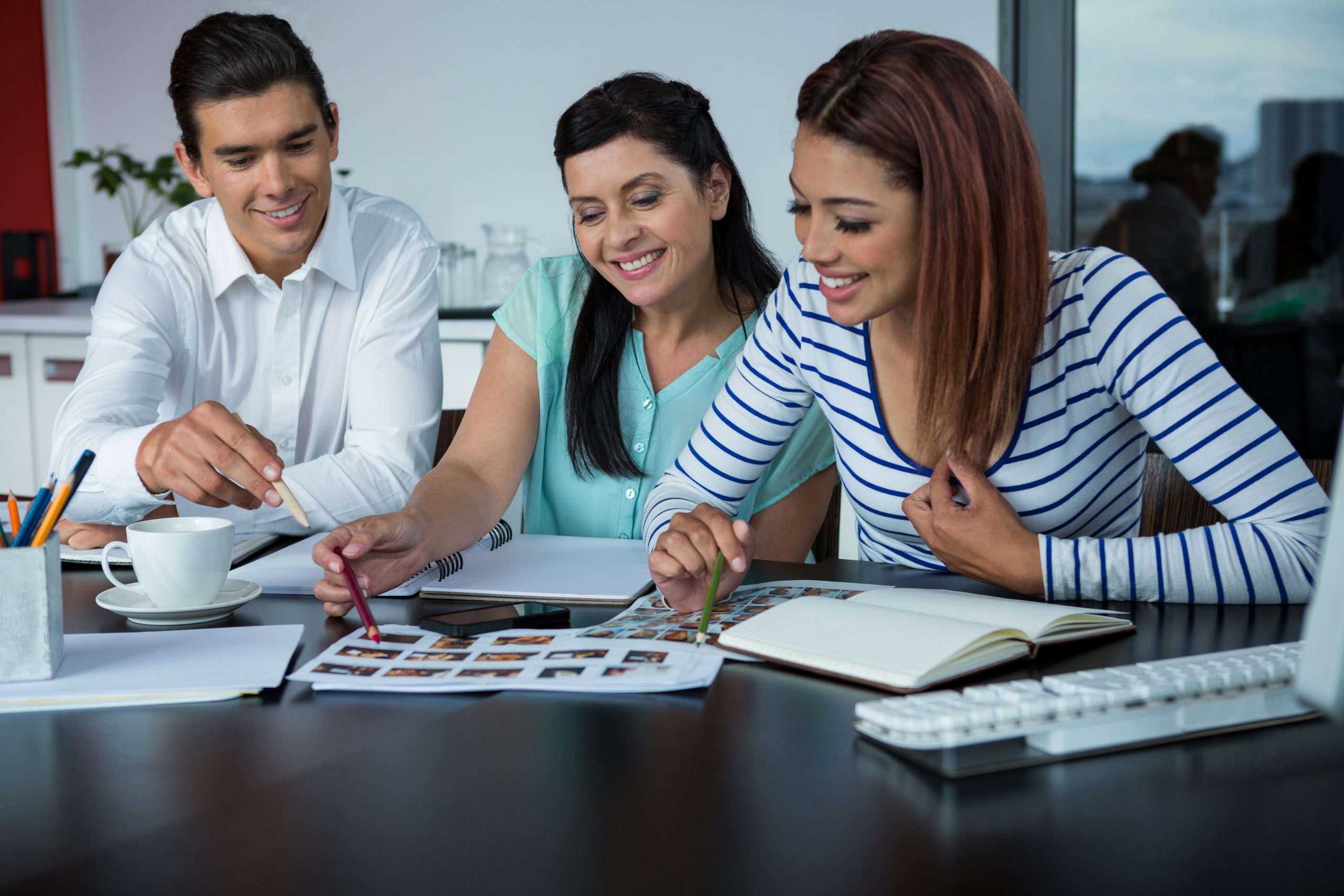 A diverse team of CA, CS, and tax professionals in a collaborative workplace meeting.